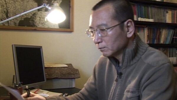 In this image taken from Jan 6, 2008, video footage by AP Video, Liu Xiaobo looks at documents in his home in Beijing, China. - Sputnik International