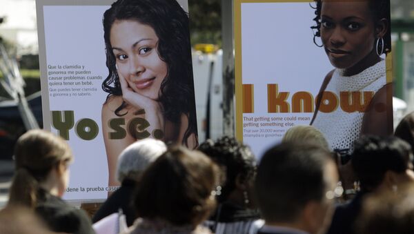 Public service posters in English and Spanish are seen at a news conference to announce a Los Angeles County program to provide young women in South Los Angeles with home-testing kits for sexually transmitted diseases, at a news conference in the Watts-Willowbrook area of Los Angeles Monday, Sept. 19, 2011. - Sputnik International