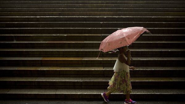 A girl carries an umbrella as she walks along steps leading to Tiananmen Square on a rainy day in Beijing, Thursday, July 6, 2017. - Sputnik International