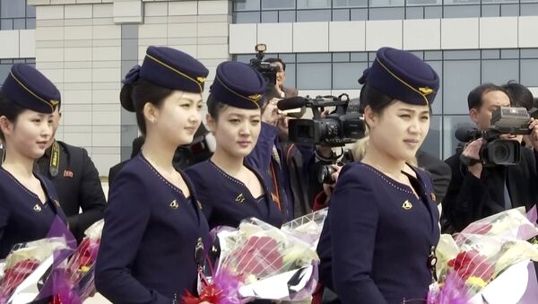 In this image taken from video, Air Koryo cabin crew wait with flowers on tarmac for the airline's first flight from Dandong, at Sunan airport in Pyongyang, North Korea Tuesday, March 28, 2017. - Sputnik International