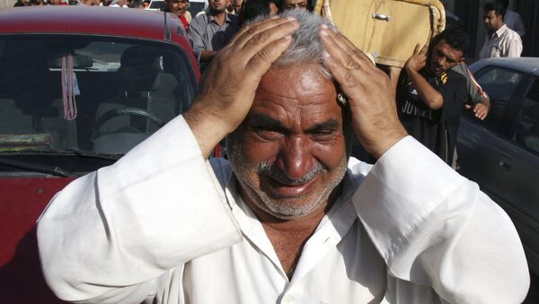 A man weeps for Saad Mozan, 42, who was killed in an overnight raid by US troops in the Shiite stronghold of Sadr City in Baghdad, Iraq on Monday, Sept. 24, 2007. - Sputnik International