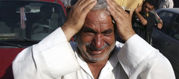 A man weeps for Saad Mozan, 42, who was killed in an overnight raid by US troops in the Shiite stronghold of Sadr City in Baghdad, Iraq on Monday, Sept. 24, 2007. - Sputnik International