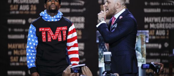 Floyd Mayweather Jr., left, and Conor McGregor pause for photos during a news conference at Staples Center Tuesday, July 11, 2017, in Los Angeles. Floyd Mayweather Jr., left, and Conor McGregor pause for photos during a news conference at Staples Center Tuesday, July 11, 2017, in Los Angeles. - Sputnik International