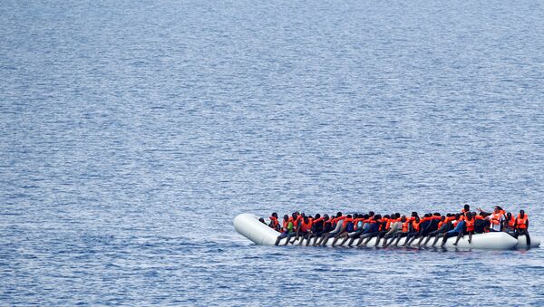 Migrants wait to be rescued by Save the Children NGO crew in the Mediterranean sea off Libya coast, June 18, 2017. - Sputnik International