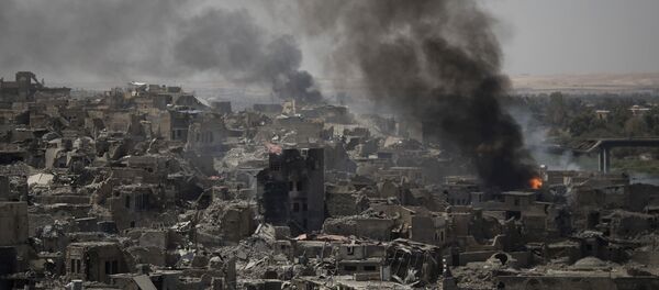 Smoke billows after airstrikes hit Islamic State positions on the edge of the Old City a day after Iraq's prime minister declared total victory in Mosul, Iraq, Tuesday, July 11, 2017. - Sputnik International