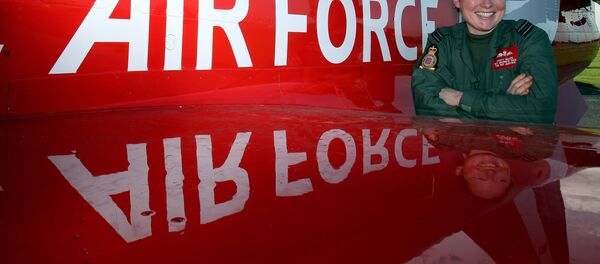 Flight Lieutenant Kirsty Moore poses in front of a Hawk aircraft at the Royal Air Force base at Scampton, England, Thursday Nov. 12, 2009, after being named as the first female pilot to serve with the Red Arrows, the RAF's aerobatic team. Flight Lieutenant Kirsty Moore poses in front of a Hawk aircraft at the Royal Air Force base at Scampton, England, Thursday Nov. 12, 2009, after being named as the first female pilot to serve with the Red Arrows, the RAF's aerobatic team. - Sputnik International