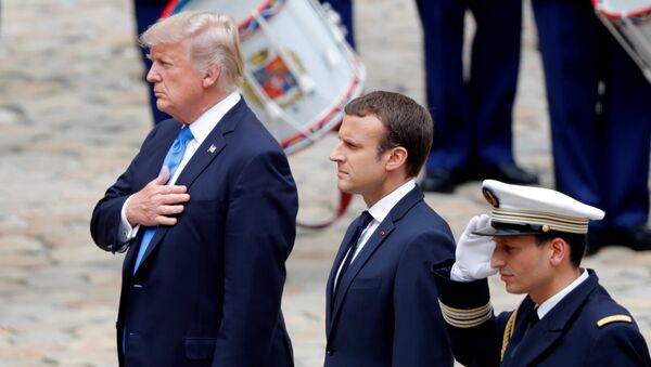 French President Emmanuel Macron and U.S. President Donald Trump listen to national anthems during a welcoming ceremony at the Invalides in Paris, France, July 13, 2017. - Sputnik International