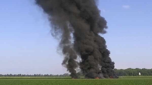 In this photo provided by Jimmy Taylor, smoke and flames rise into the air after a military transport airplane crashed in a field near Itta Bena, Miss., on the western edge of Leflore County, Monday, July 10, 2017, killing several. - Sputnik International