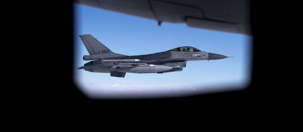 Seen through the window of another aircraft, an Royal Netherlands Air Force F- 16 military fighter jet participating in NATO's Baltic Air Policing Mission operates in Lithuanian airspace during a Ramstein Alloy air force exercise, Tuesday, April 25, 2017 - Sputnik International