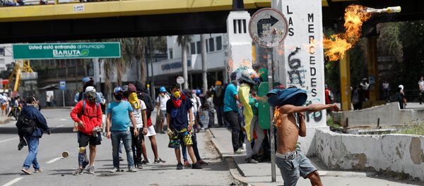 A demonstrator throws a molotov cocktail during clashes with security forces at a rally against Venezuelan President Nicolas Maduro's government in Caracas, Venezuela July 10, 2017 A demonstrator throws a molotov cocktail during clashes with security forces at a rally against Venezuelan President Nicolas Maduro's government in Caracas, Venezuela July 10, 2017 - Sputnik International