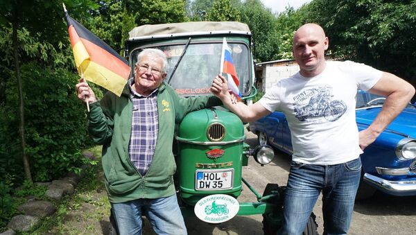Retired Winfried Langner, left, drives a tractor from Germany to Russia. He made a pit stop in Kaliningrad en route from Lower Saxony to St. Petersburg - Sputnik International