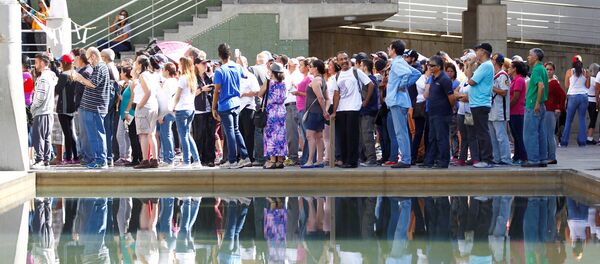People stand in line to cast their votes at a polling station during an unofficial plebiscite against Venezuela's President Nicolas Maduro's government and his plan to rewrite the constitution, in Caracas, Venezuela July 16, 2017 - Sputnik International