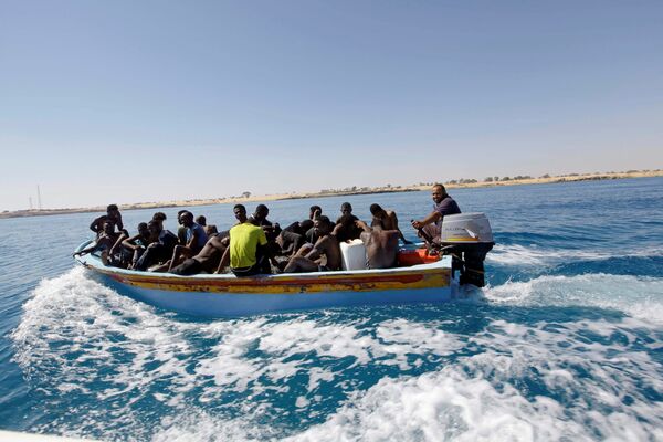 Migrants ride in a boat after they were rescued by Libyan coastguard off the coast of Gharaboli, east of Tripoli, Libya July 8, 2017 Migrants ride in a boat after they were rescued by Libyan coastguard off the coast of Gharaboli, east of Tripoli, Libya July 8, 2017 - Sputnik International