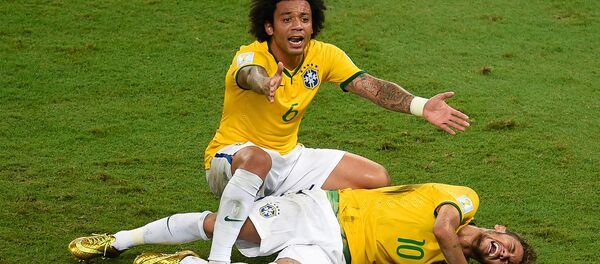 Brazil's defender Marcelo (back) reacts over Brazil's forward Neymar after he was injured following a tackle during the quarter-final football match between Brazil and Colombia at the Castelao Stadium in Fortaleza during the 2014 FIFA World Cup on July 4, 2014. Brazil's defender Marcelo (back) reacts over Brazil's forward Neymar after he was injured following a tackle during the quarter-final football match between Brazil and Colombia at the Castelao Stadium in Fortaleza during the 2014 FIFA World Cup on July 4, 2014. - Sputnik International