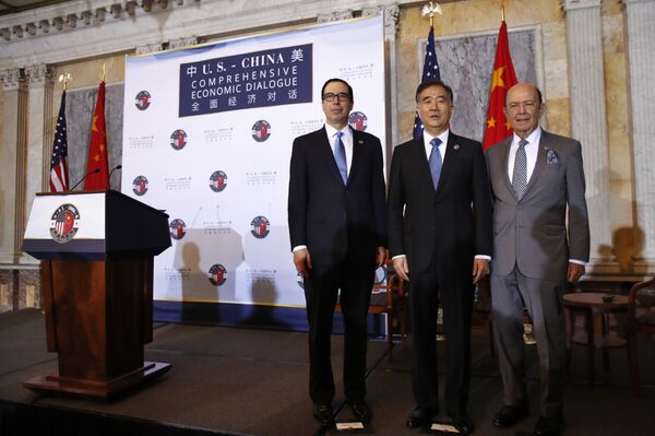 From left, Treasury Secretary Steve Mnuchin, Chinese Vice Premier Wang Yang, and Commerce Secretary Wilbur Ross pose for a group photograph before speaking at the opening of the U.S.-China Comprehensive Economic Dialogue, Wednesday, July 19, 2017, at the Treasury Department in Washington. - Sputnik International
