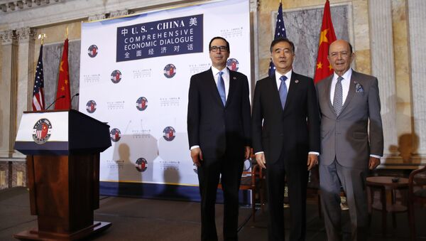 From left, Treasury Secretary Steve Mnuchin, Chinese Vice Premier Wang Yang, and Commerce Secretary Wilbur Ross pose for a group photograph before speaking at the opening of the U.S.-China Comprehensive Economic Dialogue, Wednesday, July 19, 2017, at the Treasury Department in Washington. - Sputnik International