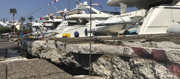 The broken quay wall is raised by several inches in the harbor after an earthquake in Kos on the island of Kos, Greece Friday, July 21, 2017. Greek authorities said two tourists killed in the overnight quake are from Turkey and Sweden. The broken quay wall is raised by several inches in the harbor after an earthquake in Kos on the island of Kos, Greece Friday, July 21, 2017. Greek authorities said two tourists killed in the overnight quake are from Turkey and Sweden. - Sputnik International