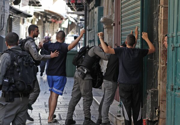 (File) Israeli security forces frisk a Palestinian youth in the Jerusalem's Old City on July 14, 2017, following an alleged attack. Three assailants opened fire on Israeli police in Jerusalem's Old City before fleeing to a nearby highly sensitive holy site and being killed by security forces, Israeli police said. (File) Israeli security forces frisk a Palestinian youth in the Jerusalem's Old City on July 14, 2017, following an alleged attack. Three assailants opened fire on Israeli police in Jerusalem's Old City before fleeing to a nearby highly sensitive holy site and being killed by security forces, Israeli police said. - Sputnik International