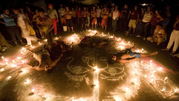 In this photo taken late Sunday, Oct. 11, 2009, followers of Maria Lionza's cult lie down inside a circle formed by candles during their annual ritual at Sorte Mountain, in Venezuela’s Yaracuy state. - Sputnik International