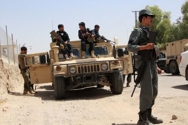 Afghan security personnel sit on atop an armoured vehicles amid an ongoing battle with Taliban militants in the Gereshk district of Helmand province on July 22, 2017 Afghan security personnel sit on atop an armoured vehicles amid an ongoing battle with Taliban militants in the Gereshk district of Helmand province on July 22, 2017 - Sputnik International