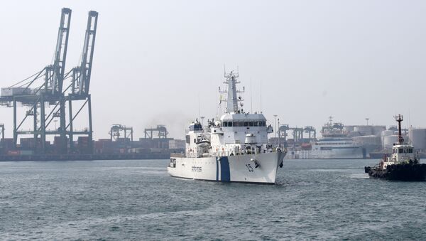 Indian Coast Guard Ship (ICGS) Shaunak a new offshore patrol vessel (L) is escorted by a tug as she arrives at port in Chennai on March 19, 2017, making her maiden visit after commissioning into the coastguard eastern fleet in Goa - Sputnik International