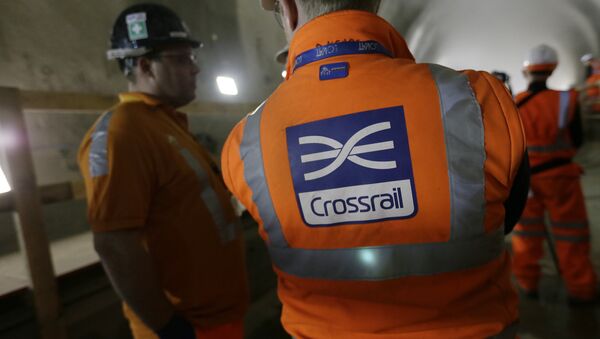 Workers talk as tunnel boring machine Victoria breaks into the eastern end of the Liverpool Street Crossrail station in London, Tuesday, March 10, 2015. - Sputnik International