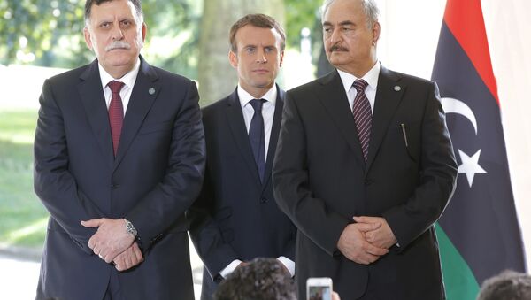 Libya's Prime Minister Fayez al-Sarraj of the U.N.-backed government, left, France's President Emmanuel Macron, center, and General Khalifa Hifter of the Egyptian-backed commander of Libya's self-styled national army shake hands listen to France's President Emmanuel Macron after a declaration at the Chateau of the La Celle-Saint-Cloud, west of Paris, France, Tuesday, July 25, 2017. - Sputnik International
