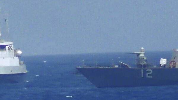 This handout image provided Tuesday, July 25, 2017, from the U.S. Navy purports to show an Iranian vessel making a close approach to a U.S. coastal patrol ship USS Thunderbolt, right. The U.S. Navy patrol boat fired warning shots near the Iranian vessel that American sailors said came dangerously close to them during a tense encounter in the Persian Gulf. - Sputnik International