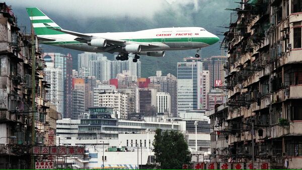 Hong Kong flag carrier Cathay Pacific, Boeing 747-400 jumbo jet, flies over the Kai Tak Airport control tower - Sputnik International