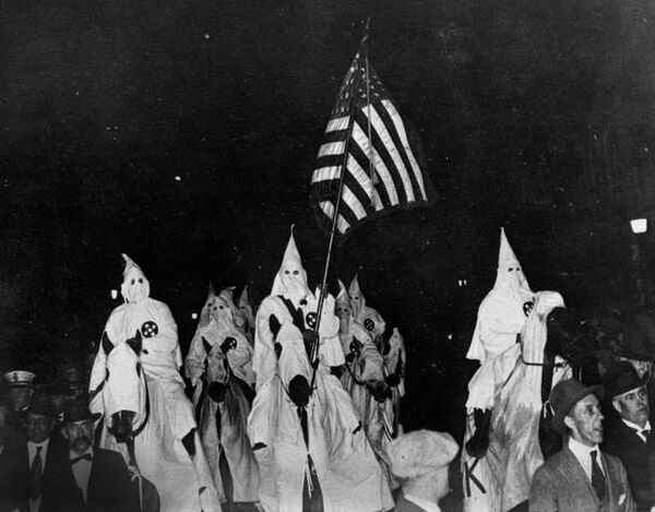 In this September 21, 1923 file photo, members of the Ku Klux Klan ride horses during a parade through the streets of Tulsa, Okla. - Sputnik International