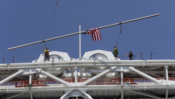 Construction workers place the final piece of steel in the superstructure that will support the retractable roof over the Arthur Ashe Stadium, Wednesday, June 10, 2015, in New York. - Sputnik International