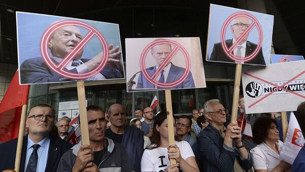   People demonstrate, outside the office of the ruling party leader Jaroslaw Kaczynski, holding banners with the images of from left, financier George Soros ,President of the European Council Donald Tusk and First Vice-President of the European Commission Frans Timmermans, during a protest, in Warsaw, Poland, Wednesday, July 26, 2017 - Sputnik International