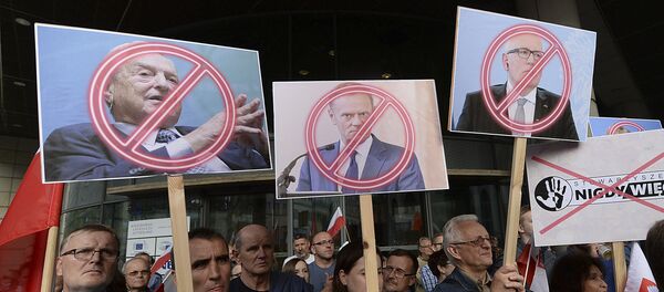 People demonstrate, outside the office of the ruling party leader Jaroslaw Kaczynski, holding banners with the images of from left, financier George Soros ,President of the European Council Donald Tusk and First Vice-President of the European Commission Frans Timmermans, during a protest, in Warsaw, Poland, Wednesday, July 26, 2017 People demonstrate, outside the office of the ruling party leader Jaroslaw Kaczynski, holding banners with the images of from left, financier George Soros ,President of the European Council Donald Tusk and First Vice-President of the European Commission Frans Timmermans, during a protest, in Warsaw, Poland, Wednesday, July 26, 2017 - Sputnik International