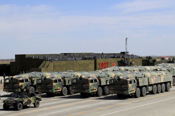 In this photo released by China's Xinhua News Agency, military vehicles carrying missiles for both nuclear and conventional strikes are driven past the VIP stage during a military parade to commemorate the 90th anniversary of the founding of the People's Liberation Army at Zhurihe training base in north China's Inner Mongolia Autonomous Region, Sunday, July 30, 2017 - Sputnik International