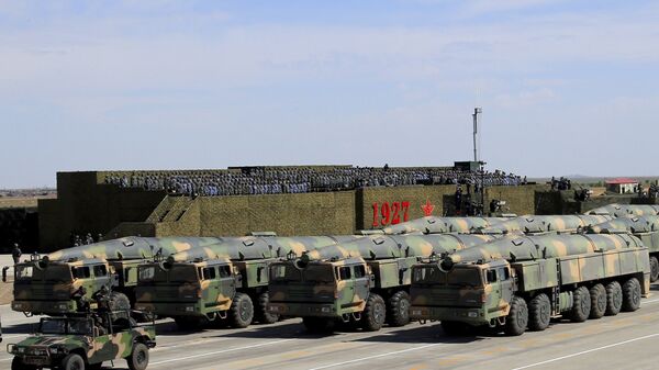 In this photo released by China's Xinhua News Agency, military vehicles carrying missiles for both nuclear and conventional strikes are driven past the VIP stage during a military parade to commemorate the 90th anniversary of the founding of the People's Liberation Army at Zhurihe training base in north China's Inner Mongolia Autonomous Region, Sunday, July 30, 2017 - Sputnik International