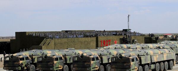 In this photo released by China's Xinhua News Agency, military vehicles carrying missiles for both nuclear and conventional strikes are driven past the VIP stage during a military parade to commemorate the 90th anniversary of the founding of the People's Liberation Army at Zhurihe training base in north China's Inner Mongolia Autonomous Region, Sunday, July 30, 2017 - Sputnik International