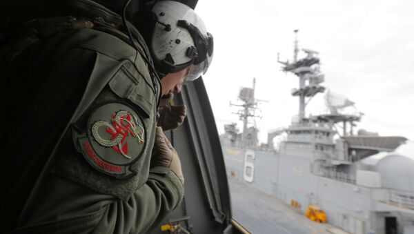 A crewman aboard a U.S. Marine MV-22B Osprey aircraft looks out as it lifts off the deck of the USS Bonhomme Richard amphibious assault ship off the coast of Sydney, Australia, Thursday, June 29, 2017 after a ceremony on board the ship marking the start of Talisman Saber 2017, a biennial joint military exercise between the United States and Australia - Sputnik International