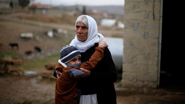 Ayman, a boy from a minority Yazidi community, who was sold by Islamic State militants to a Muslim couple in Mosul, hugs his grandmother after he was returned to his Yazidi family, in Duhok, Iraq, January 31, 2017 - Sputnik International