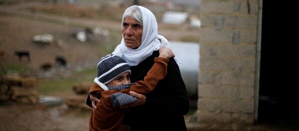 Ayman, a boy from a minority Yazidi community, who was sold by Islamic State militants to a Muslim couple in Mosul, hugs his grandmother after he was returned to his Yazidi family, in Duhok, Iraq, January 31, 2017 Ayman, a boy from a minority Yazidi community, who was sold by Islamic State militants to a Muslim couple in Mosul, hugs his grandmother after he was returned to his Yazidi family, in Duhok, Iraq, January 31, 2017 - Sputnik International