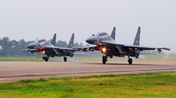 In this undated file photo released Saturday, Aug. 6, 2016, by China's Xinhua News Agency, two Chinese SU-30 fighter jets take off from an unspecified location to fly a patrol over the South China Sea - Sputnik International