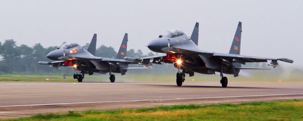 In this undated file photo released Saturday, Aug. 6, 2016, by China's Xinhua News Agency, two Chinese SU-30 fighter jets take off from an unspecified location to fly a patrol over the South China Sea - Sputnik International