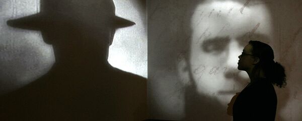 A member of staff poses stands in front of a screen showing a short movie about Jack the Ripper during a press preview for the exhibition Jack the Ripper and the East End at the Museum in Docklands, London, Wednesday, May 14, 2008. - Sputnik International