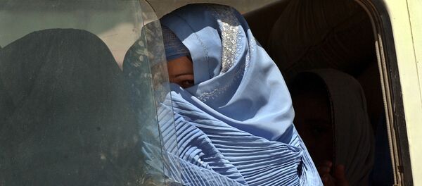 Woman clad in burka peeps from the window of a bus (File) Woman clad in burka peeps from the window of a bus (File) - Sputnik International