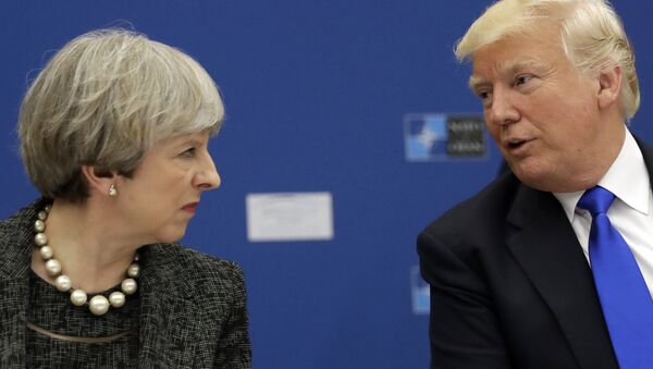 US President Donald Trump, right, speaks to British Prime Minister Theresa May during in a working dinner meeting at the NATO headquarters during a NATO summit of heads of state and government in Brussels on Thursday, May 25, 2017. - Sputnik International