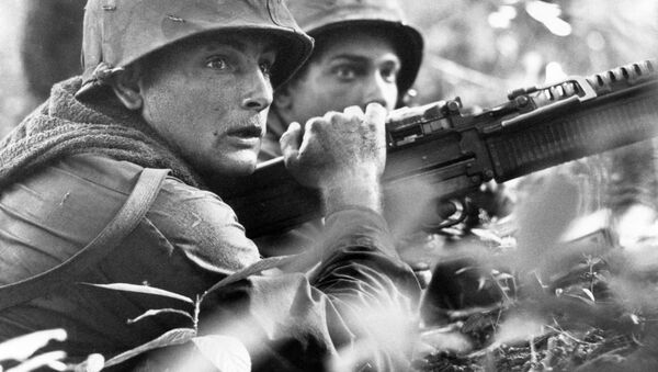 U.S. machine gunner Spc. 4 James R. Pointer, left, of Cedartown, Ga., and Pfc. Herald Spracklen of Effingham, Ill., peer from the brush of an overgrown rubber plantation near the Special Forces camp at Bu Dop during a half hour firefight, Dec. 5, 1967 - Sputnik International