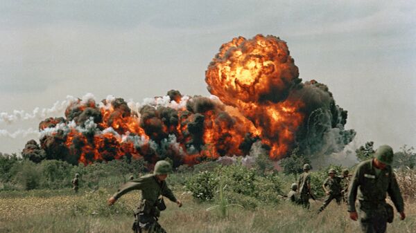 A napalm strike erupts in a fireball near U.S. troops on patrol in South Vietnam, 1966 during the Vietnam War - Sputnik International