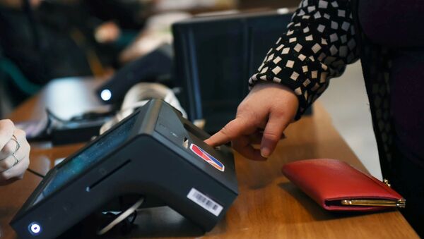 A woman touches a fingerprint scanner - Sputnik International