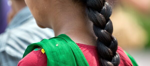 A Indian girl with a traditional hair style walks in New Delhi. (File) A Indian girl with a traditional hair style walks in New Delhi. (File) - Sputnik International