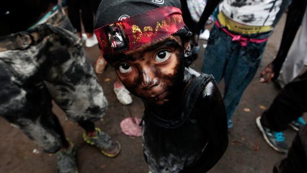 A girl covered in motor oil takes part in the festivities honouring the capital's patron saint Santo Domingo de Guzman in Managua, Nicaragua - Sputnik International