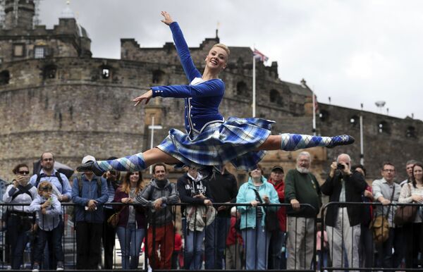 Highland Dancer Elayne Seaton from the Tattoo Dance Company performs on the Edinburgh Castle esplanade after the Royal Edinburgh Military Tattoo programme was revealed by Brigadier David Allfrey, chief executive and producer of the Tattoo, in Edinburgh Highland Dancer Elayne Seaton from the Tattoo Dance Company performs on the Edinburgh Castle esplanade after the Royal Edinburgh Military Tattoo programme was revealed by Brigadier David Allfrey, chief executive and producer of the Tattoo, in Edinburgh - Sputnik International